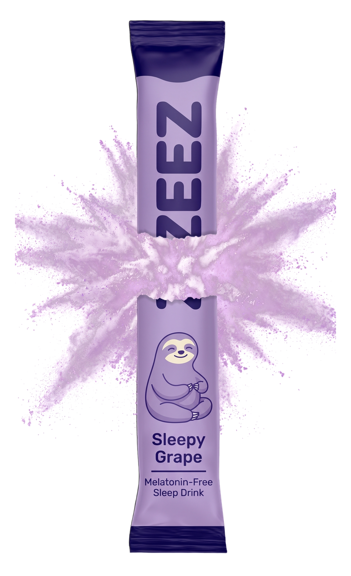 A ZEEZ Sleepy Grape stick pack torn in two along one shared tear, with lavender powder bursting out between the halves.